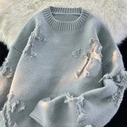 Lichtblauwe gebreide sweater met franjes en sierlijke scheuren front view