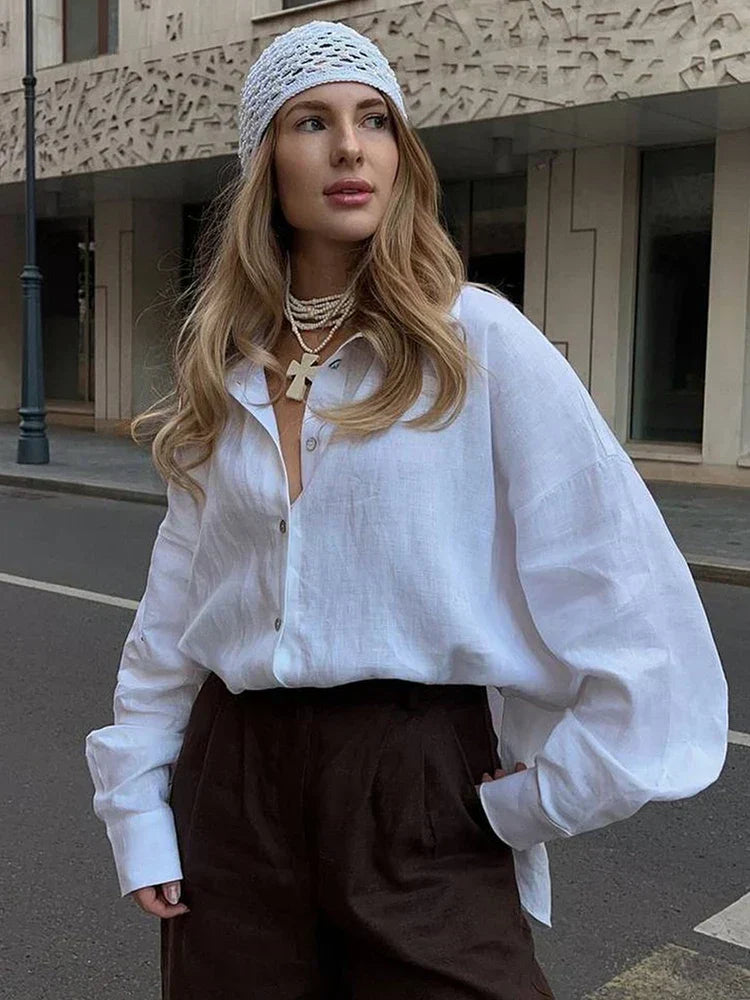 White linen blouse with black pants and headband, street style