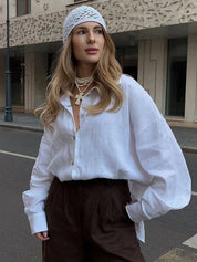 White linen blouse with black pants and headband, street style