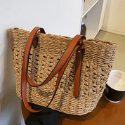 Woven cross-stitch tote bag beige on table with coffee cup