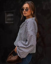 Woman wearing black and white checkered shirt, side profile