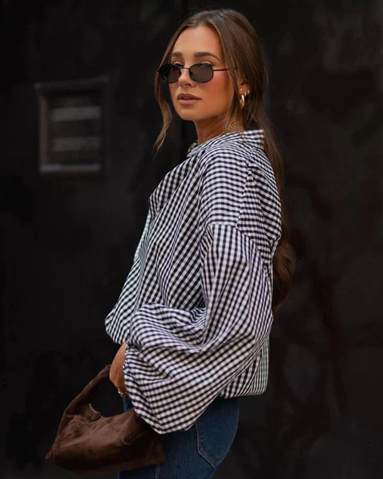 Woman wearing black and white checkered shirt, side profile