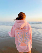 Pink hoodie with sunset design beach setting