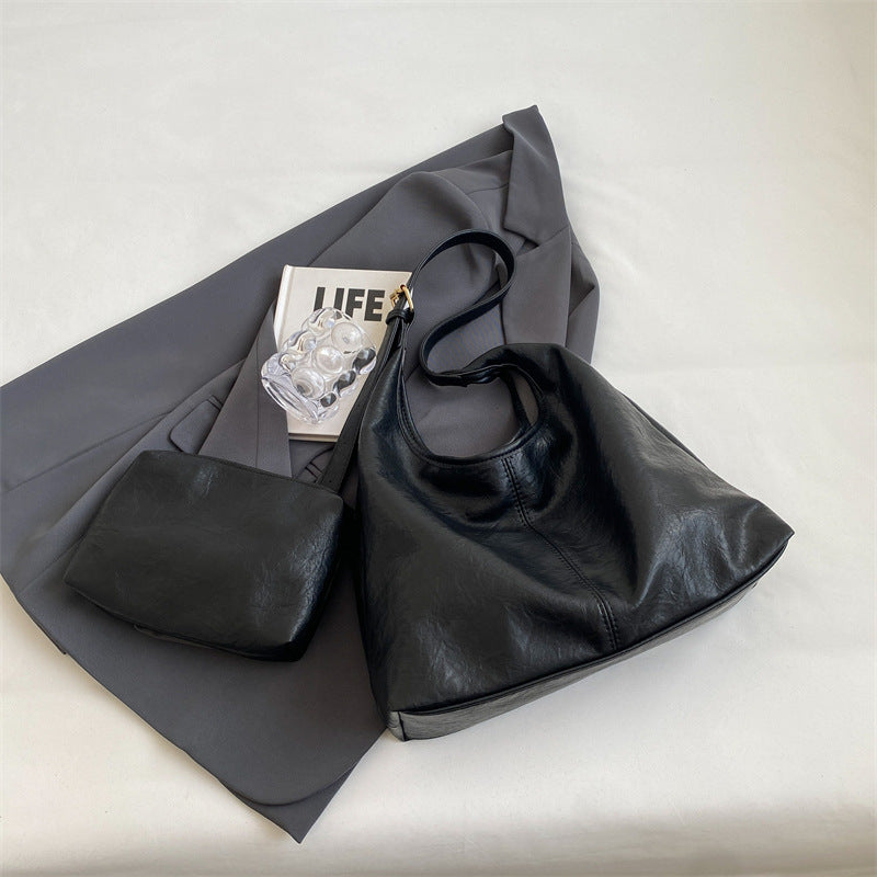 Black leather hobo bag styled with accessories