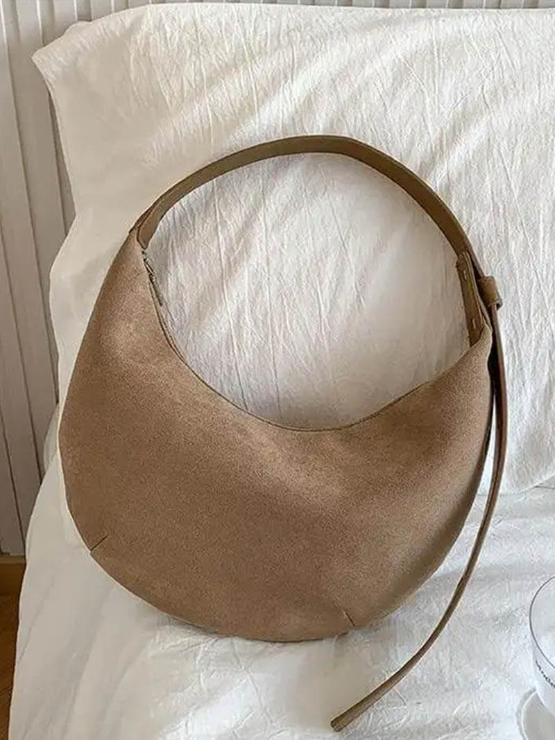 Hobo bag in beige suede on white fabric, front view