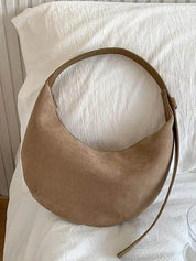 Hobo bag in beige suede on white fabric, front view