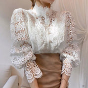 White lace blouse with puffed sleeves close-up on model