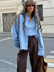 Light blue linen blouse with brown pants, street style