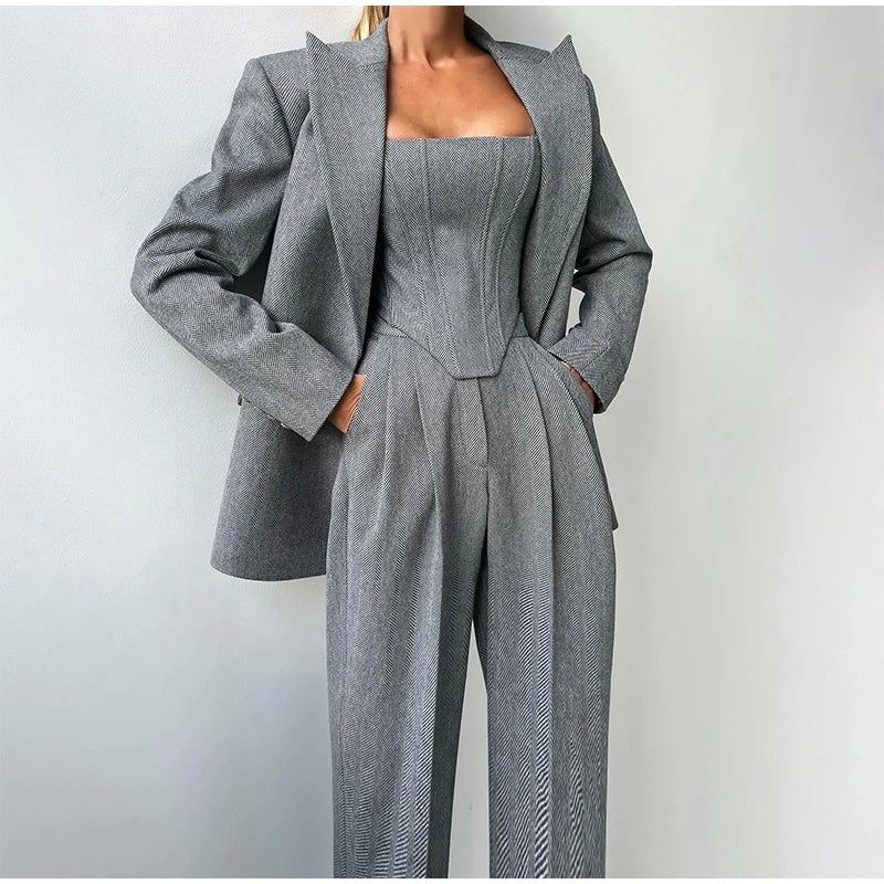 Gray herringbone suit with blazer and wide pants front view, hands in pockets