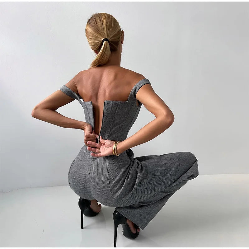 Gray herringbone jumpsuit with blazer and wide pants back view, hands on hips