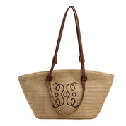 Woven straw tote bag with monogram embroidery front view