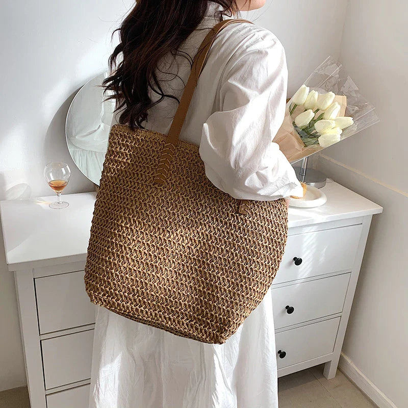 Woven straw tote bag beige worn over shoulder
