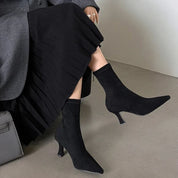 Black suede ankle boots with pointed toe, front view