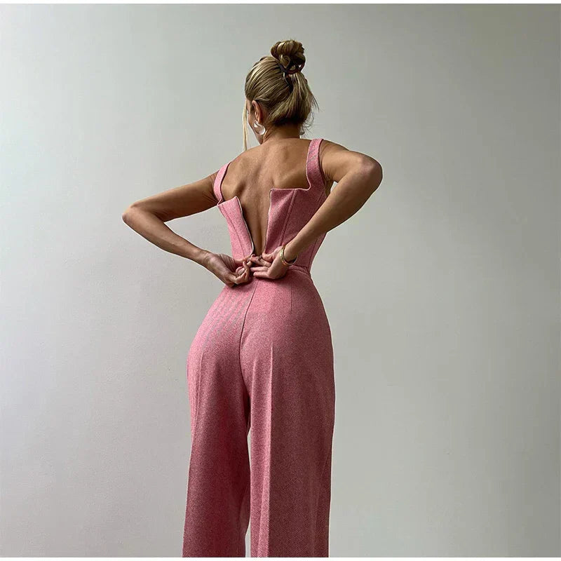 Pink herringbone jumpsuit with blazer and wide pants back view, hands on hips
