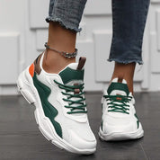 Chunky sneakers white with green and orange accents angled view