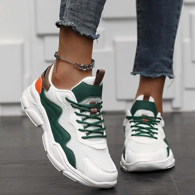 Chunky sneakers white with green and orange accents angled view