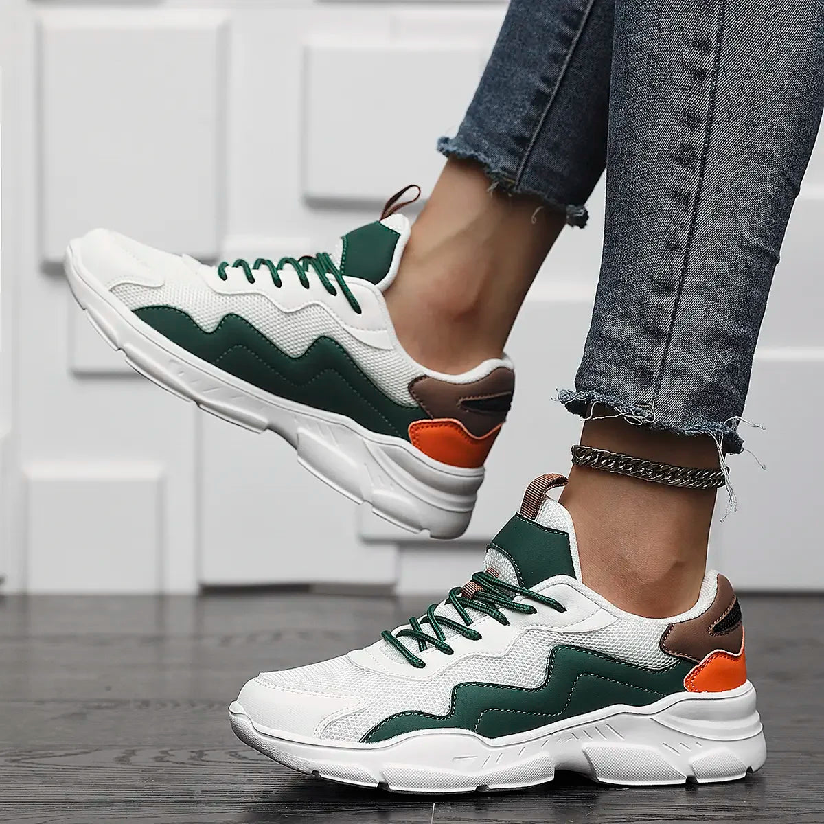 Chunky sneakers white with green and orange accents angled view