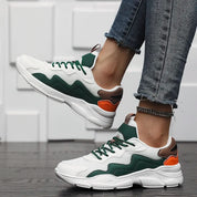 Chunky sneakers white with green and orange accents angled view