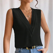 Black blouse with V-neck and pleats, close-up detail