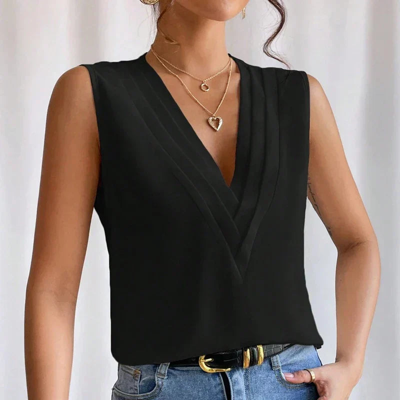 Black blouse with V-neck and pleats, close-up detail