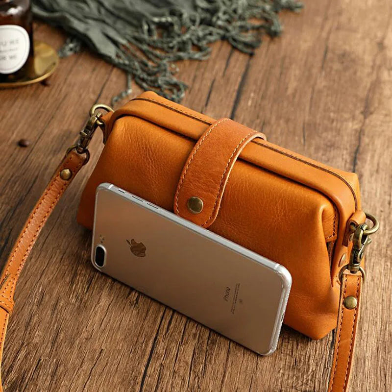 Orange leather crossbody bag with smartphone