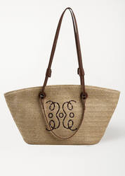 Woven straw tote bag with monogram detail front view