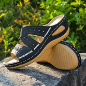 Black leather sandals with floral embroidery angled view