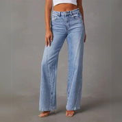Light blue denim jeans front view with model wearing white top