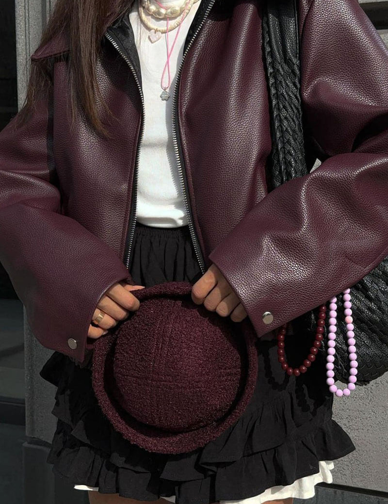 Oversized faux leather jacket maroon close-up of zipper
