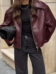 Oversized faux leather jacket maroon worn with jeans
