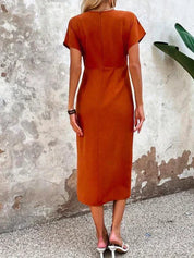 Midi dress orange with V-neck and side slit back view