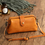 Orange leather crossbody bag angled view