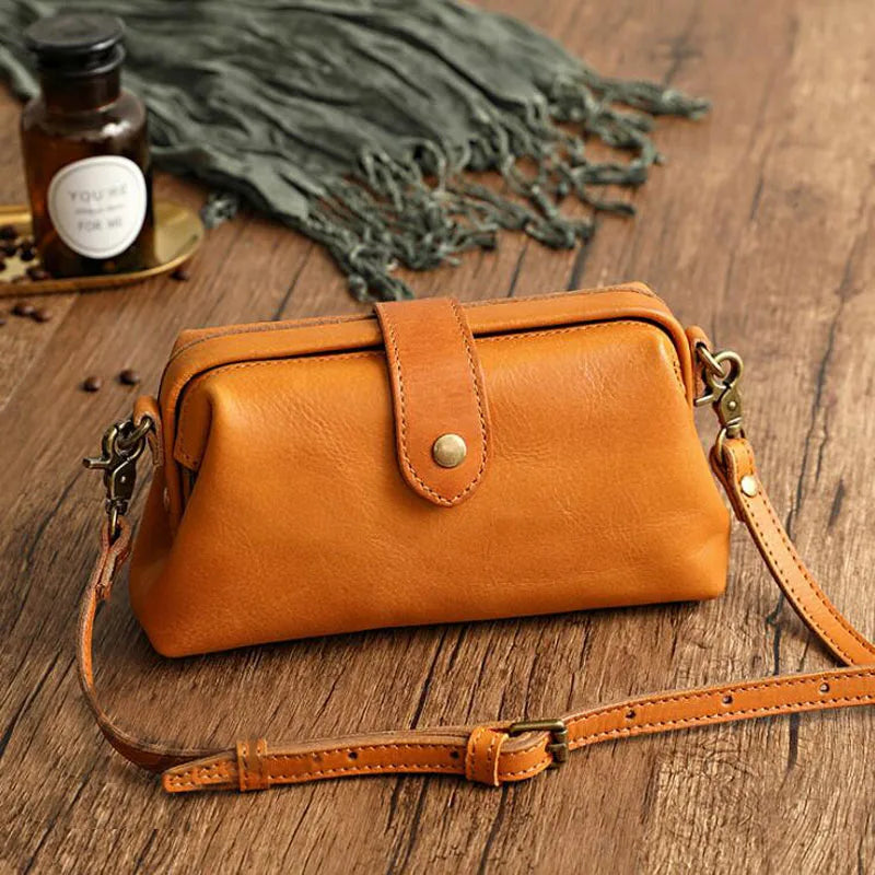 Orange leather crossbody bag angled view