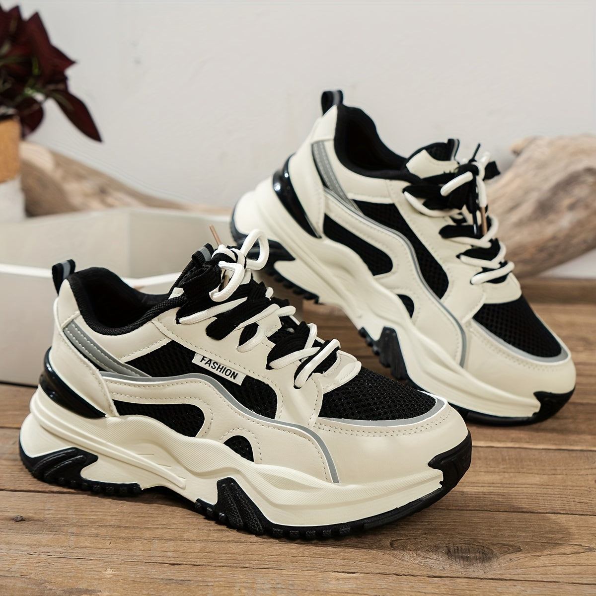 White and black chunky sneakers with mesh detail close-up
