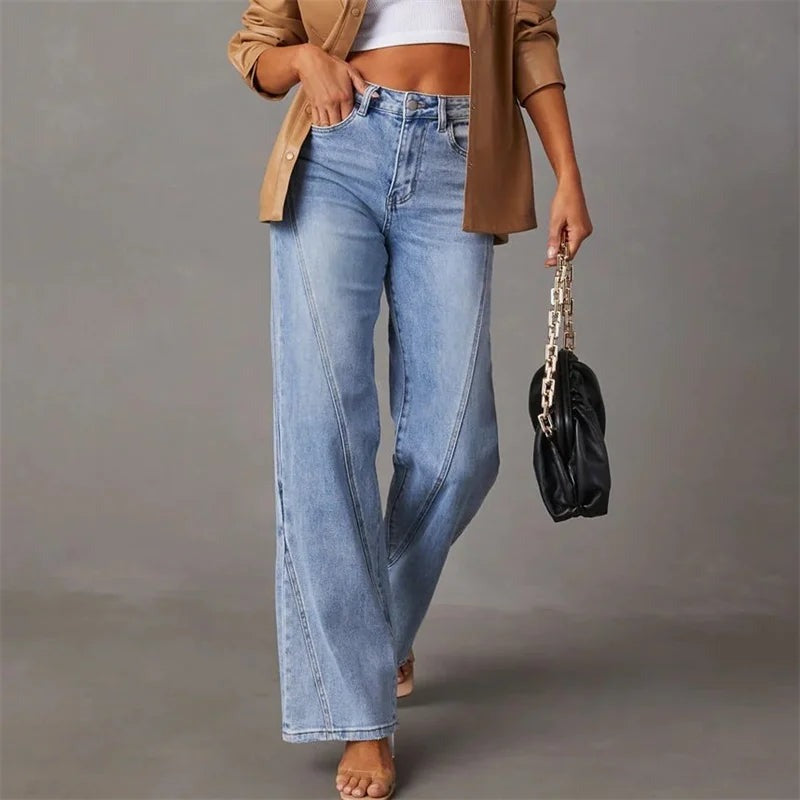 Light blue denim jeans front view with model wearing beige blazer and black bag