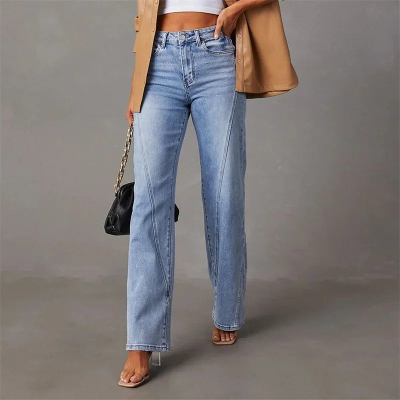 Light blue denim jeans front view with model wearing beige blazer and black bag