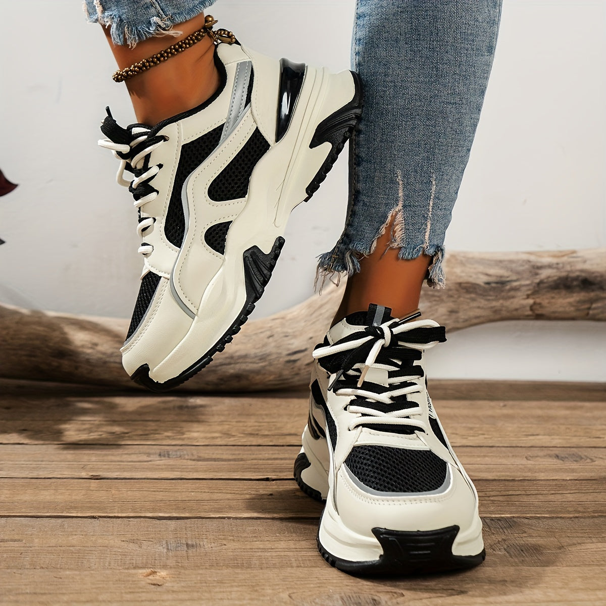 White and black chunky sneakers with mesh detail angled view