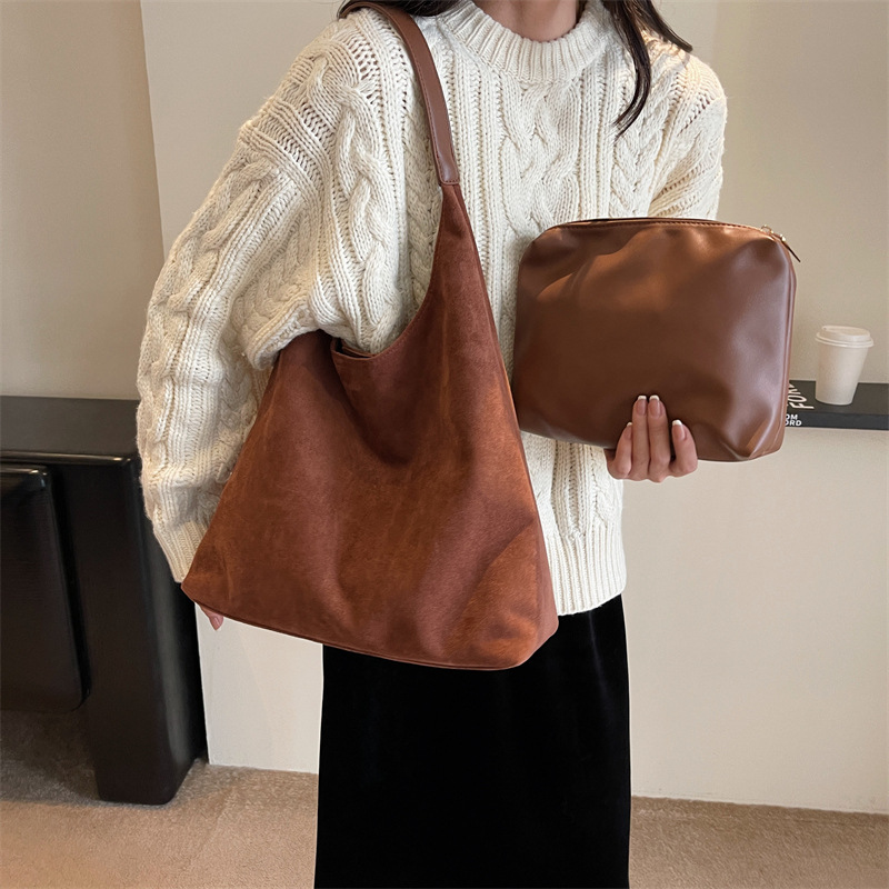Brown suede hobo bag worn with white sweater