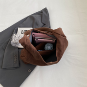 Brown suede hobo bag interior with phone and accessories