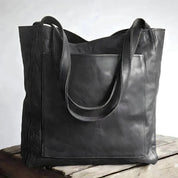 Leather tote bag with large front pocket, black color, front view