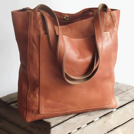 Leather tote bag with large front pocket, rust color, front view