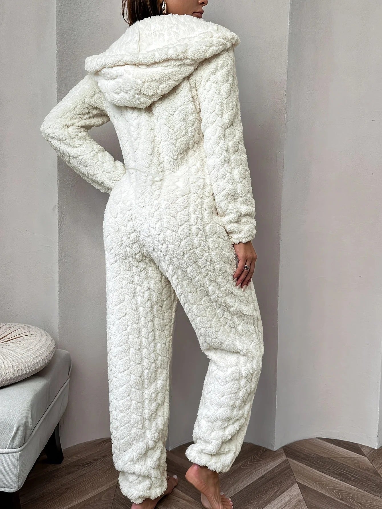 Cream plush onesie with hood and zipper, back view