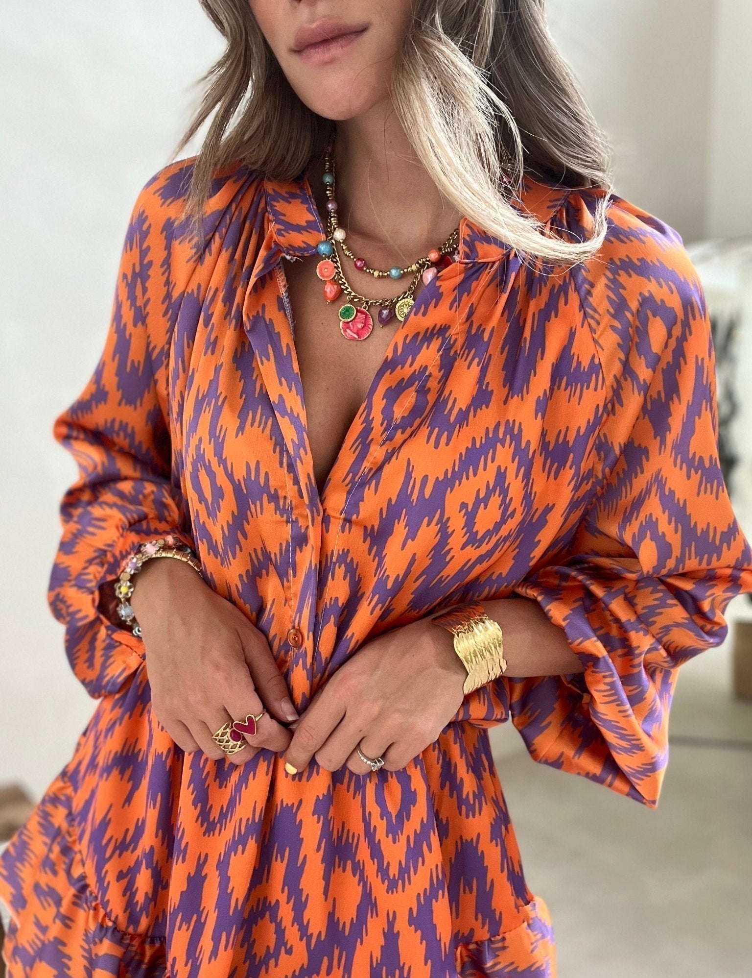 Orange and purple patterned summer dress close-up of buttons and neckline