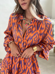 Orange and purple patterned summer dress close-up of buttons and neckline