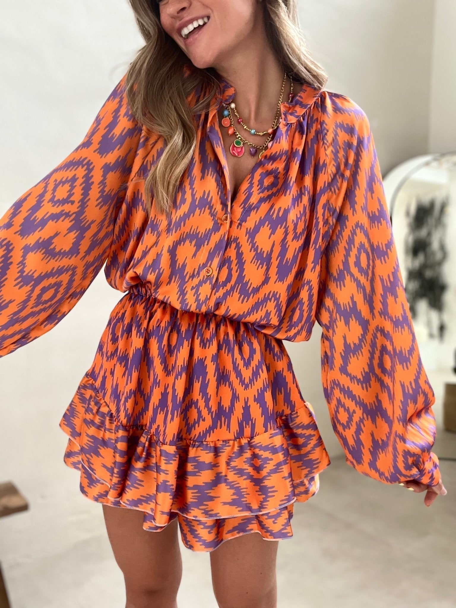 Orange and purple patterned summer dress front view with ruffle hem