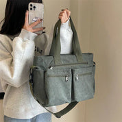 Green corduroy shoulder bag with multiple pockets, front view