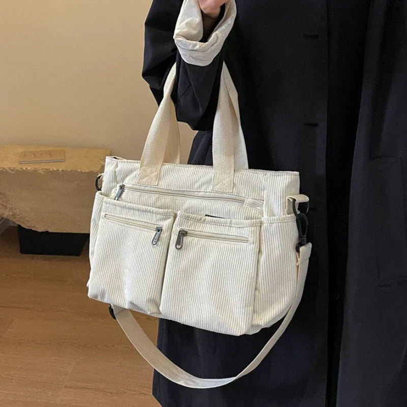 Cream corduroy shoulder bag with multiple pockets, front view