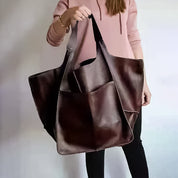 Brown slouchy tote with large exterior pockets, front view