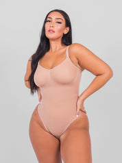 Nude shaping bodysuit front view with hands on hips