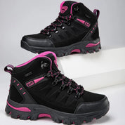 Black outdoor boots with pink accents angled view